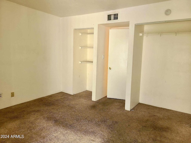 3416 N 44th St Unit 5, Phoenix, AZ 85018 - unfurnished bedroom featuring dark carpet, visible vents, and a closet