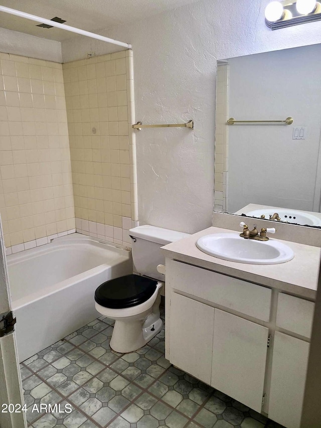 3416 N 44th St Unit 5, Phoenix, AZ 85018 - bathroom featuring tile patterned floors, shower / washtub combination, a textured wall, toilet, and vanity