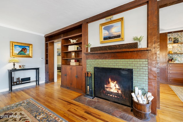 543 S Hassayampa Dr, Prescott, AZ 86303 - living room with a brick fireplace, built in shelves, ornamental molding, wood finished floors, and baseboards