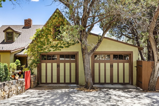 543 S Hassayampa Dr, Prescott, AZ 86303 - view of front of home with a chimney, stucco siding, a garage, and driveway