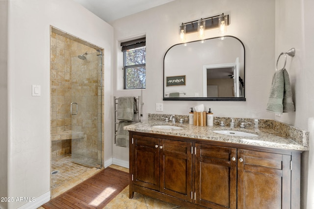 543 S Hassayampa Dr, Prescott, AZ 86303 - bathroom with a stall shower, double vanity, and baseboards