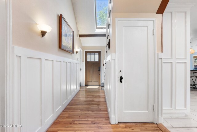 543 S Hassayampa Dr, Prescott, AZ 86303 - hall featuring a decorative wall, light wood-type flooring, a skylight, and wainscoting