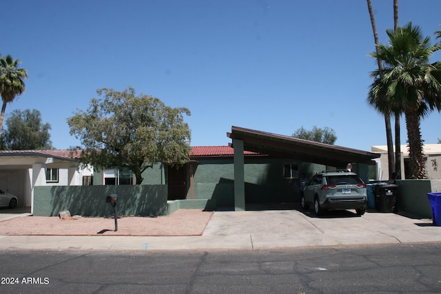 view of front of property featuring a carport