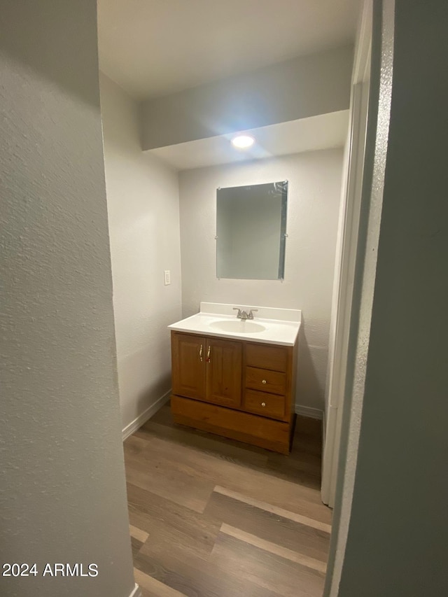 bathroom featuring hardwood / wood-style flooring and vanity