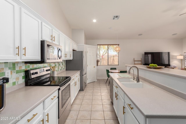 5401 S Dove Holw, Buckeye, AZ 85326 - kitchen featuring appliances with stainless steel finishes, a sink, tasteful backsplash, light countertops, and white cabinets