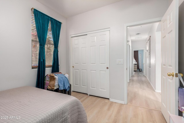 5401 S Dove Holw, Buckeye, AZ 85326 - bedroom with light wood finished floors, a closet, and baseboards