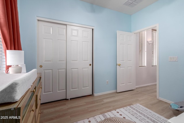 5401 S Dove Holw, Buckeye, AZ 85326 - bedroom with light wood-style floors, a closet, and baseboards
