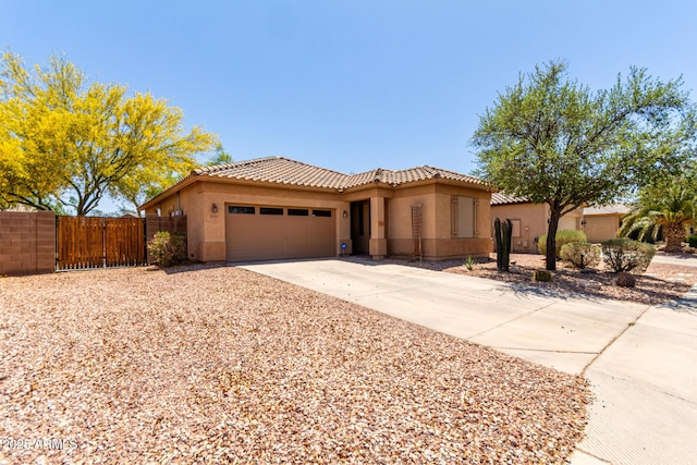 5401 S Dove Holw, Buckeye, AZ 85326 - mediterranean / spanish home featuring an attached garage, fence, stucco siding, and concrete driveway