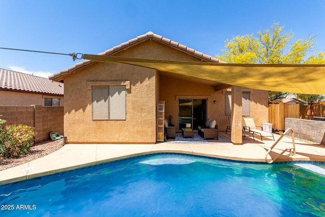 5401 S Dove Holw, Buckeye, AZ 85326 - rear view of house featuring a patio area, fence, stucco siding, and an outdoor living space
