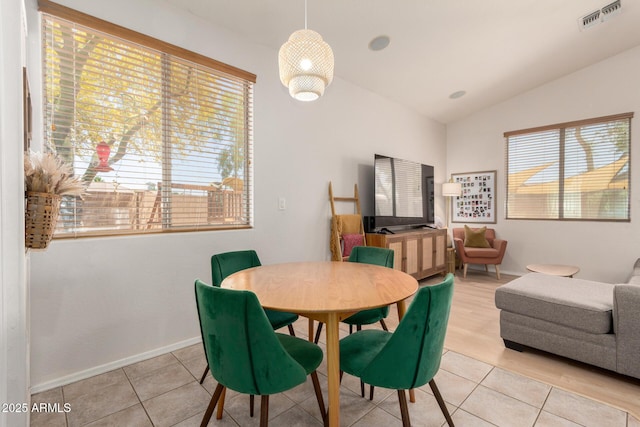 5401 S Dove Holw, Buckeye, AZ 85326 - dining area with vaulted ceiling, light tile patterned flooring, and baseboards
