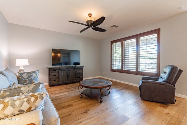 living room with ceiling fan and light hardwood / wood-style floors