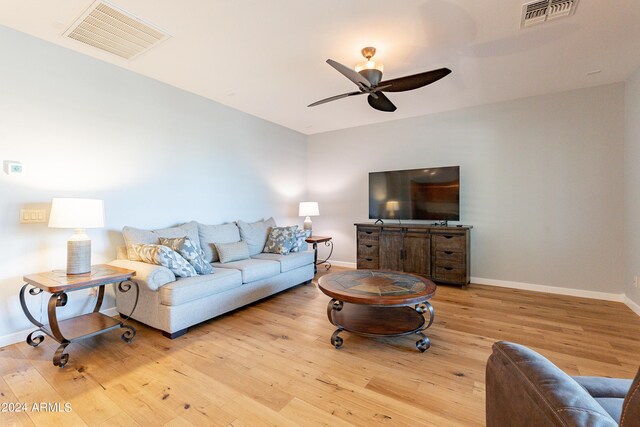 living room featuring light wood-type flooring and ceiling fan