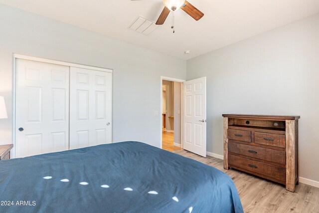 bedroom with light hardwood / wood-style flooring, a closet, and ceiling fan