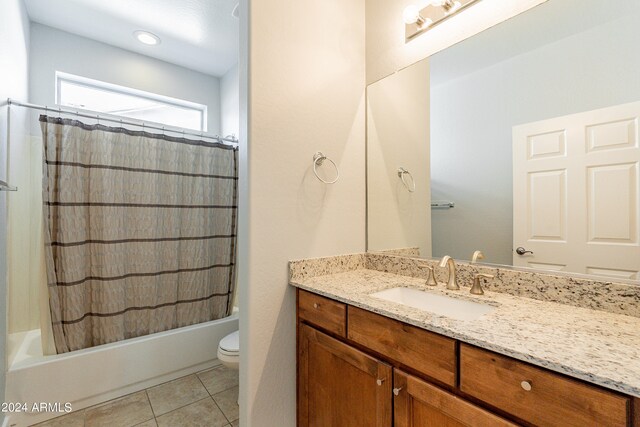 full bathroom with vanity, shower / tub combo, toilet, and tile patterned flooring