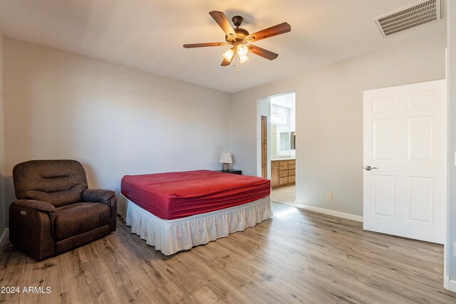 bedroom featuring ceiling fan, connected bathroom, and light hardwood / wood-style floors