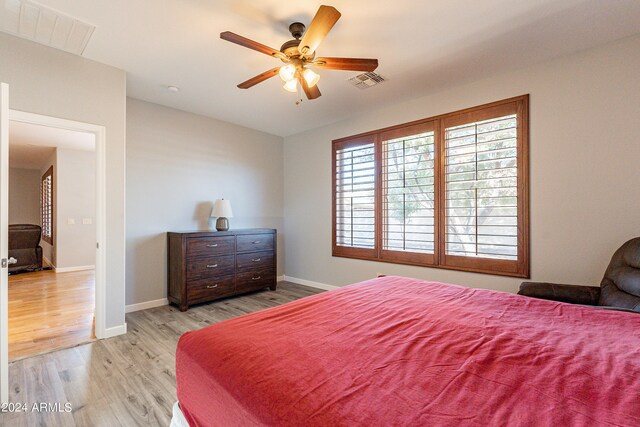 bedroom with light hardwood / wood-style floors and ceiling fan