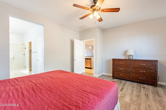 bedroom with ceiling fan, connected bathroom, and light hardwood / wood-style floors