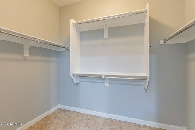 spacious closet with light tile patterned flooring