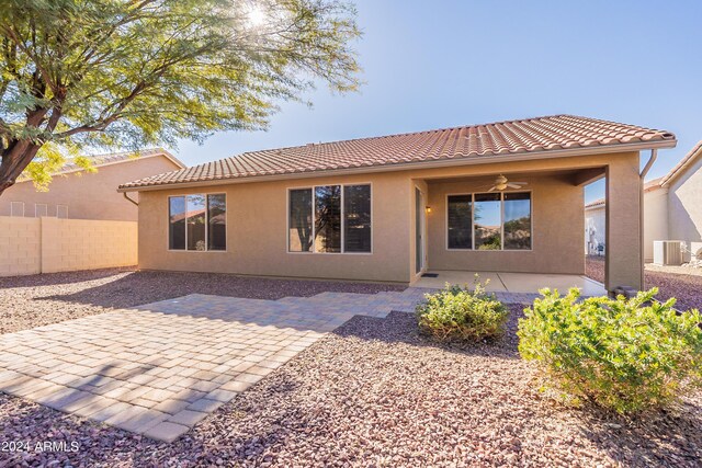 rear view of property featuring ceiling fan, a patio area, and central air condition unit