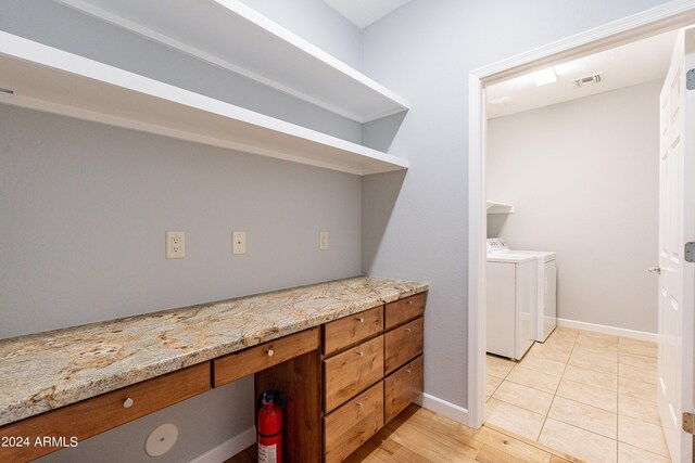 interior space with wood-type flooring and washer and dryer