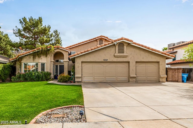15027 N 61st Pl, Scottsdale, AZ 85254 - mediterranean / spanish-style house featuring stucco siding, an attached garage, concrete driveway, and a front lawn