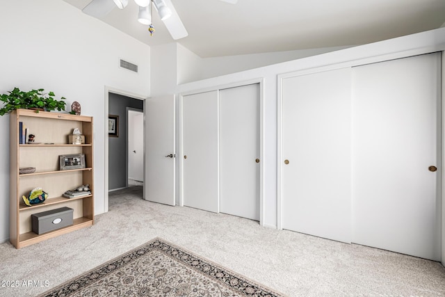 15027 N 61st Pl, Scottsdale, AZ 85254 - carpeted bedroom featuring visible vents, two closets, lofted ceiling, and a ceiling fan