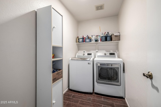 15027 N 61st Pl, Scottsdale, AZ 85254 - washroom with visible vents, baseboards, wood tiled floor, laundry area, and separate washer and dryer