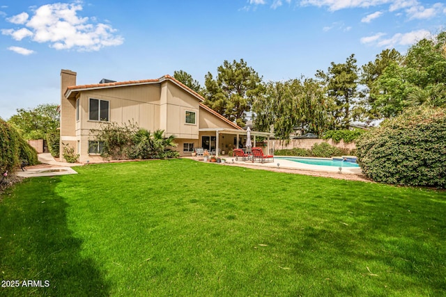 15027 N 61st Pl, Scottsdale, AZ 85254 - back of property with a patio, fence, a yard, a fenced in pool, and a chimney