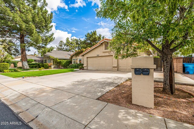 15027 N 61st Pl, Scottsdale, AZ 85254 - view of front of house featuring a tile roof, a front yard, stucco siding, a garage, and driveway