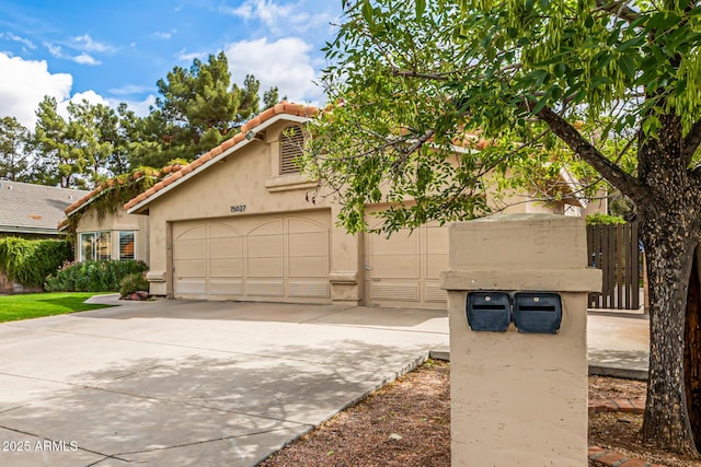 15027 N 61st Pl, Scottsdale, AZ 85254 - view of front of property featuring a tiled roof, a garage, driveway, and stucco siding