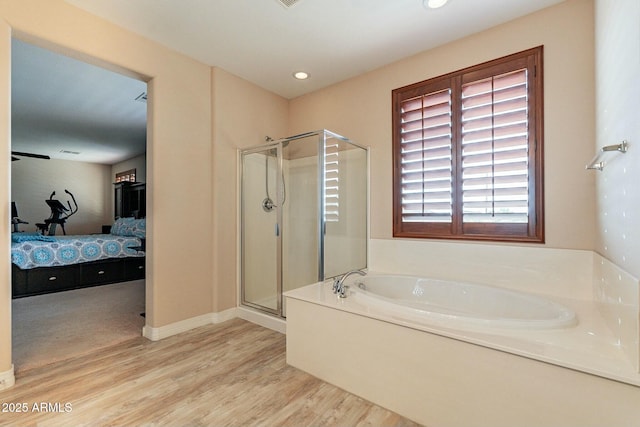 bathroom featuring ensuite bathroom, recessed lighting, wood finished floors, a bath, and a stall shower