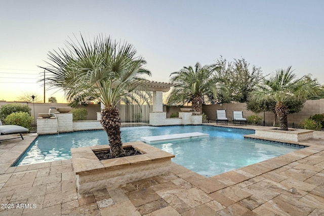 pool at dusk with a fenced in pool, a patio area, and a fenced backyard