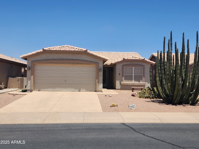 1450 E Doral Dr, Chandler, AZ 85249 - view of front of house featuring concrete driveway, an attached garage, a tiled roof, and stucco siding