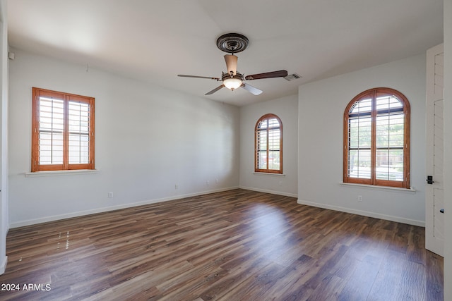 unfurnished room featuring dark hardwood / wood-style floors and ceiling fan