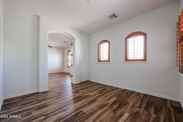 empty room featuring dark hardwood / wood-style flooring