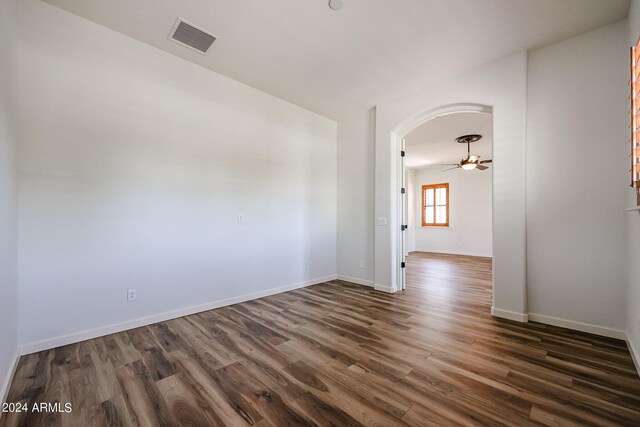 spare room featuring ceiling fan and dark hardwood / wood-style floors