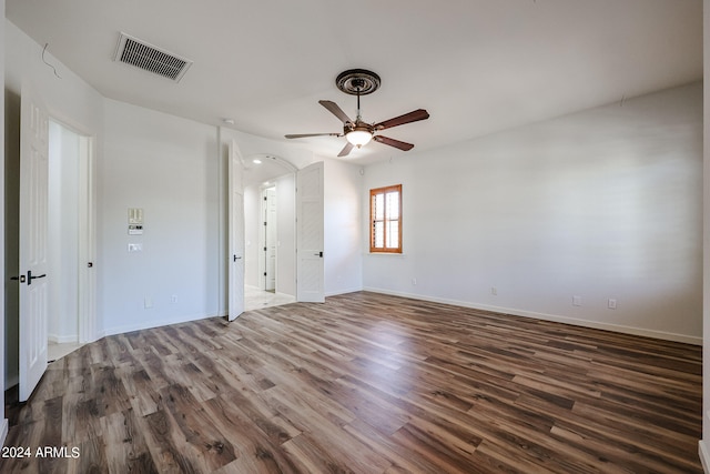 unfurnished room with ceiling fan and dark hardwood / wood-style flooring