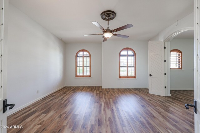 empty room featuring ceiling fan and dark hardwood / wood-style floors