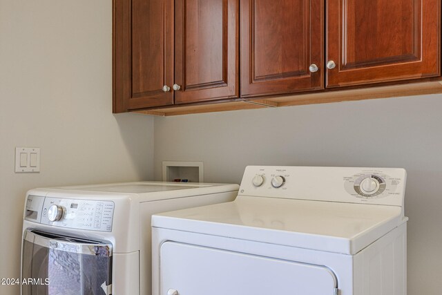 laundry room with cabinets and separate washer and dryer