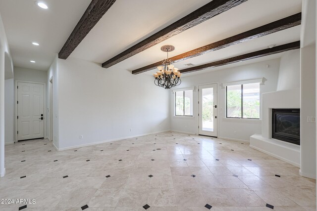 unfurnished living room with an inviting chandelier and beamed ceiling