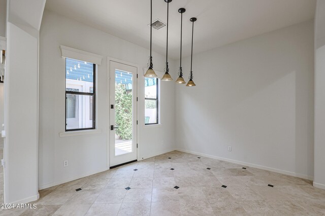 interior space featuring light tile patterned flooring and plenty of natural light