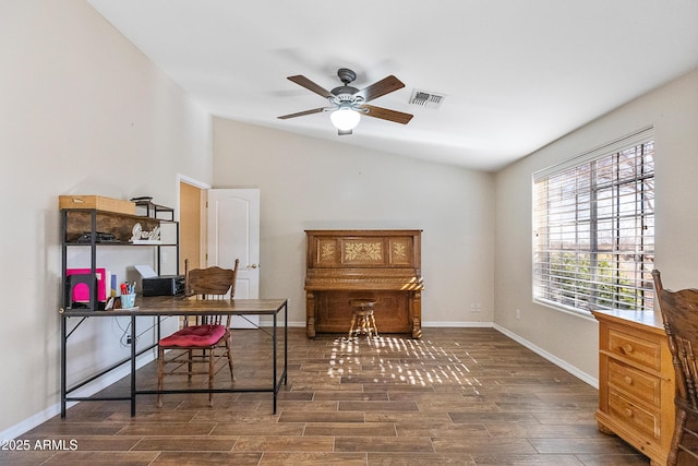 office space with dark wood-type flooring, ceiling fan, and vaulted ceiling