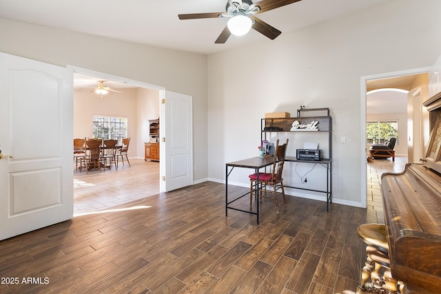 office space with dark hardwood / wood-style flooring, ceiling fan, vaulted ceiling, and a healthy amount of sunlight