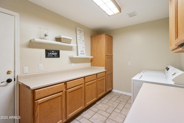 laundry room featuring independent washer and dryer and cabinets