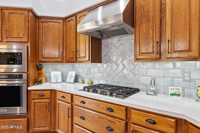 kitchen featuring stainless steel appliances, extractor fan, and backsplash