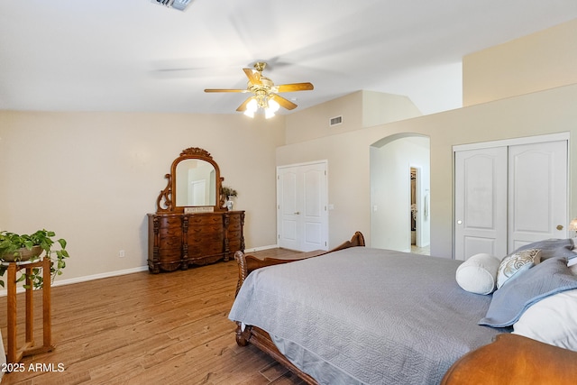 bedroom featuring vaulted ceiling, ceiling fan, light hardwood / wood-style floors, and a closet