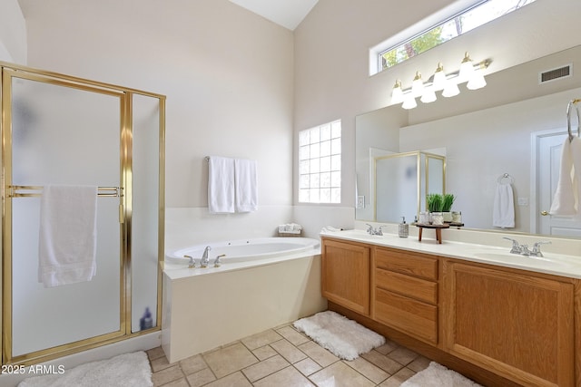 bathroom with vanity and shower with separate bathtub