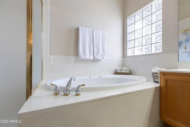 bathroom with vanity and a washtub