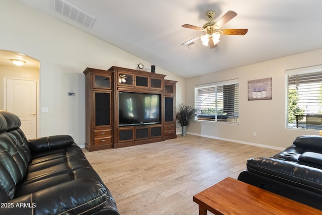 living room with lofted ceiling, ceiling fan, light hardwood / wood-style floors, and a healthy amount of sunlight