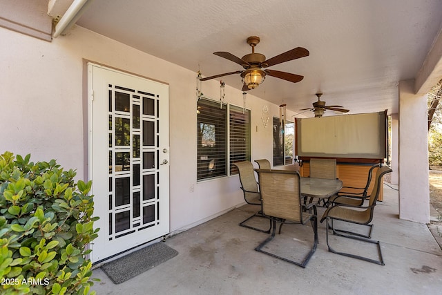 view of patio with a jacuzzi and ceiling fan